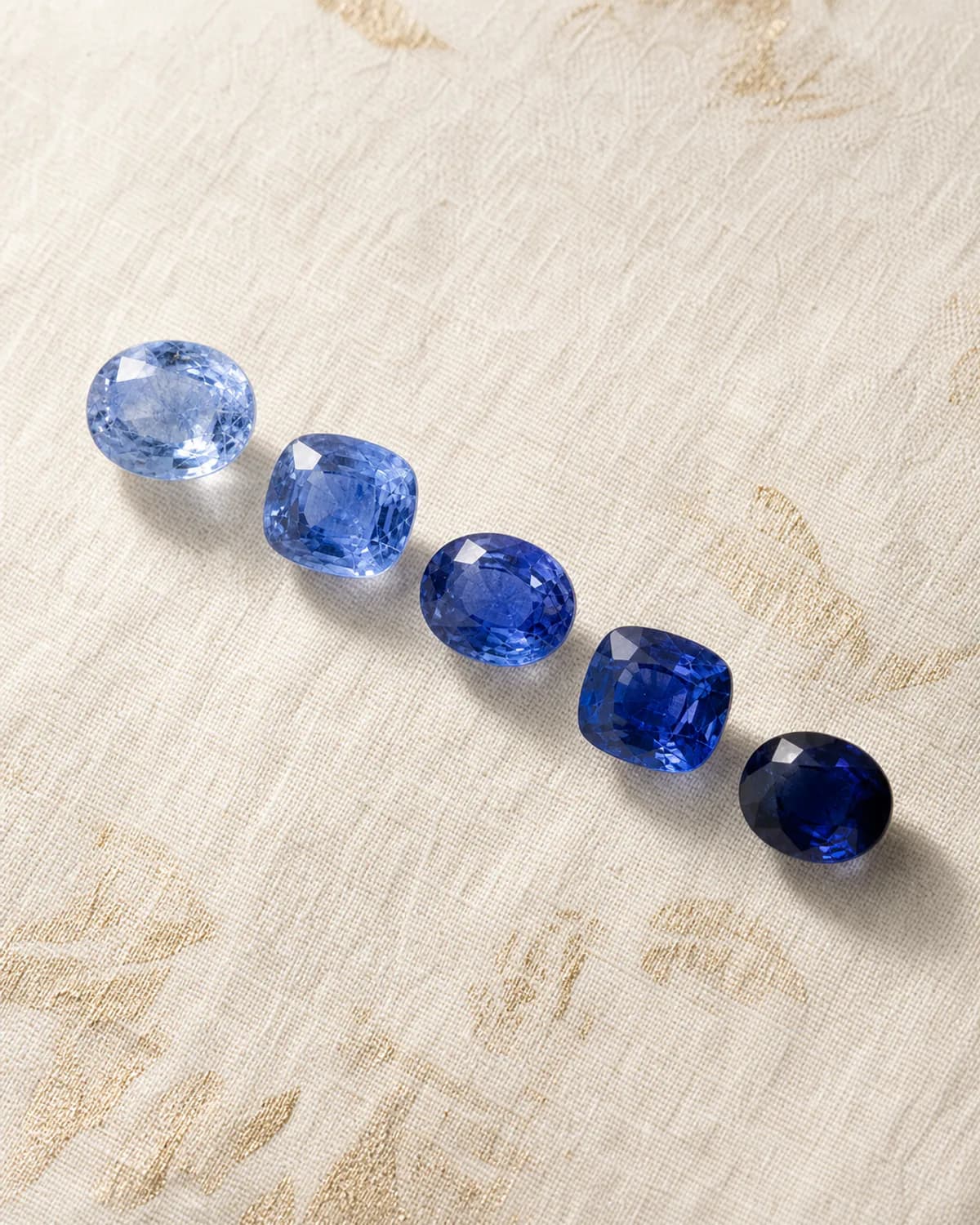 Loose Ceylon blue sapphires arranged from pale sky blue to deep royal blue