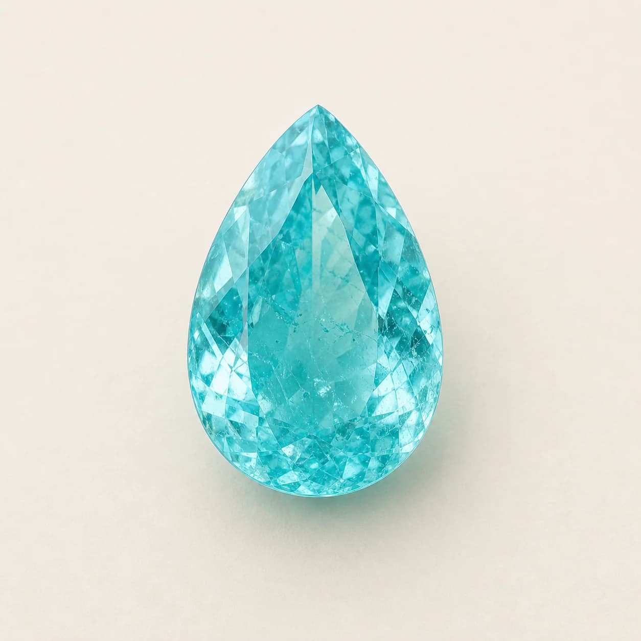 Paraíba Tourmaline 1.62ct loose gemstone on a warm ivory background